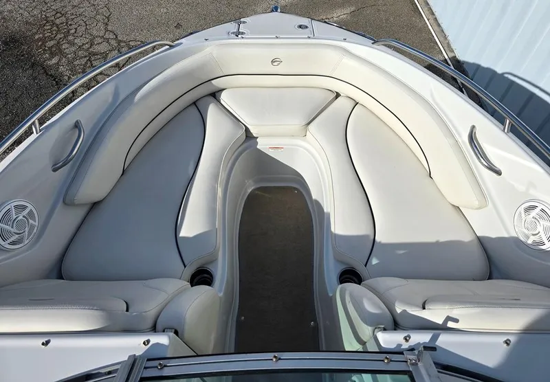 Slide: The Image of 2011 Crownline 230LS BR boat interior with white seating and speakers. - 13