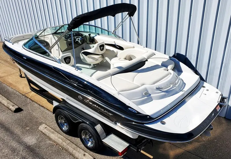 Slide: The Image of 2011 Crownline 230LS BR boat on trailer, featuring sleek design and comfortable seating. - 2