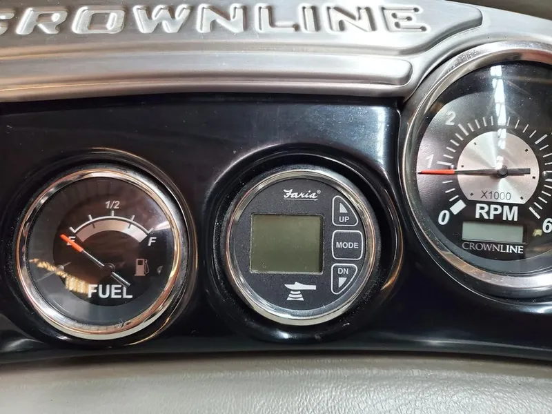 Slide: The Image of Dashboard of 2011 Crownline 230LS BR boat with fuel and RPM gauges. - 24