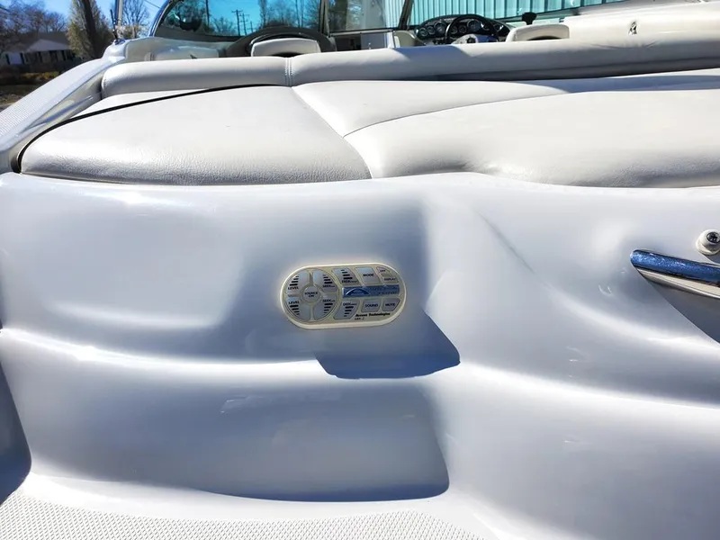 Slide: The Image of 2011 Crownline 230LS BR boat interior with white seating and speaker detail. - 28