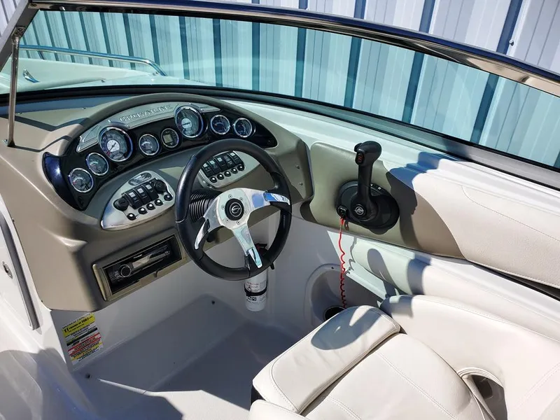 Slide: The Image of 2011 Crownline 230LS BR boat dashboard with steering wheel and control panel. - 3