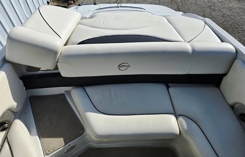 Slide: The Image of 2011 Crownline 230LS BR boat interior with white cushioned seating. - 7