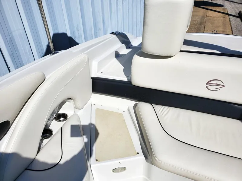 Slide: The Image of 2011 Crownline 230LS BR boat interior with white leather seating and cup holders. - 8
