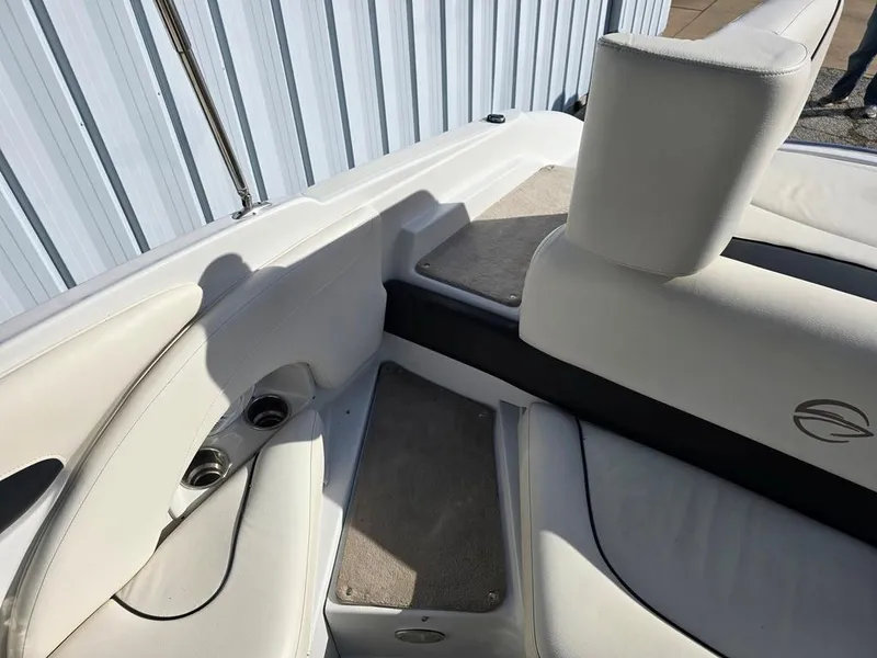 Slide: The Image of 2011 Crownline 230LS BR boat interior with white seating and cup holders. - 9