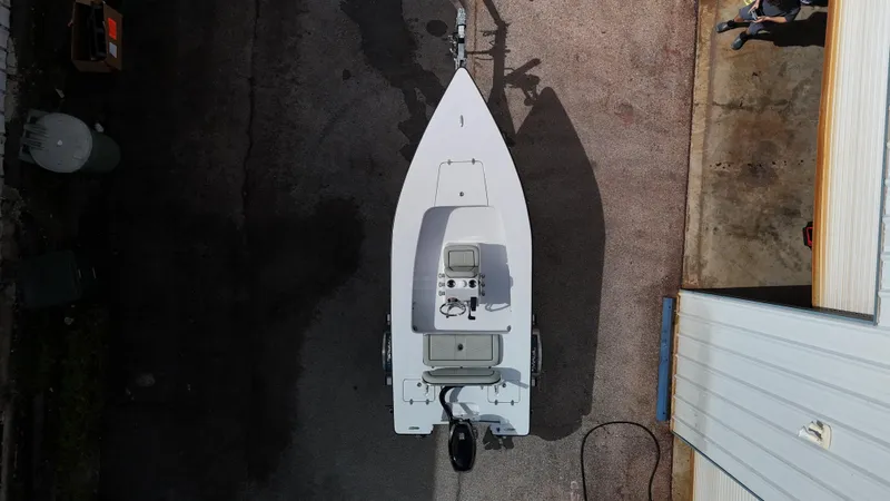 Slide: The Image of Overhead view of 2025 Custom Texar Flats Hybrid 16 boat on trailer. - 11