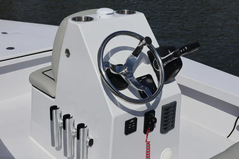 Slide: The Image of Steering console of 2025 Custom Texar Flats Hybrid 16 boat, featuring modern controls and rod holders. - 3