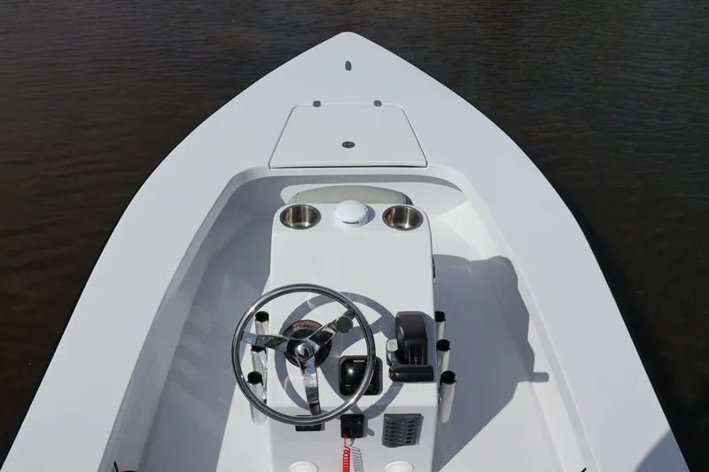 Slide: The Image of Custom Texar Flats Hybrid 16 boat, 2025 model, featuring a sleek white deck and steering console. - 4