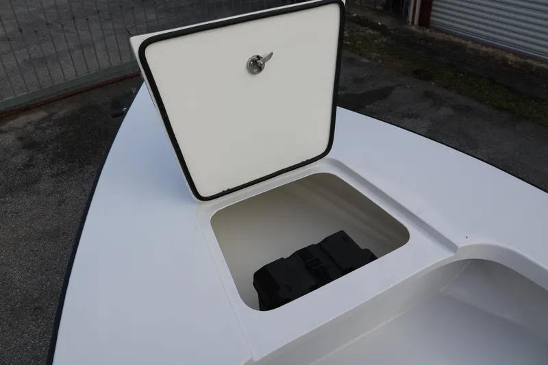 Slide: The Image of Open storage compartment on 2025 Custom Texar Flats Hybrid 16 boat. - 6