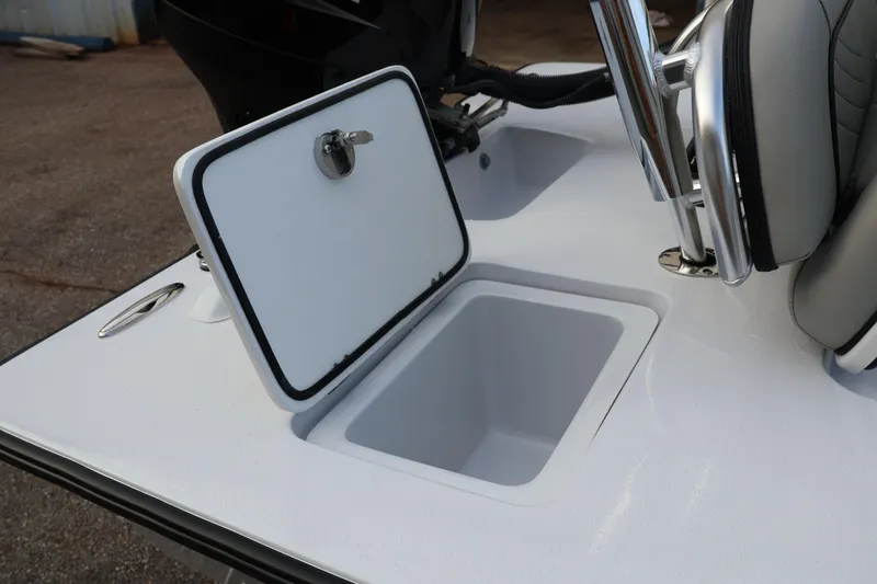 Slide: The Image of Open storage compartment on 2025 Texar Flats Hybrid 16 boat deck. - 7