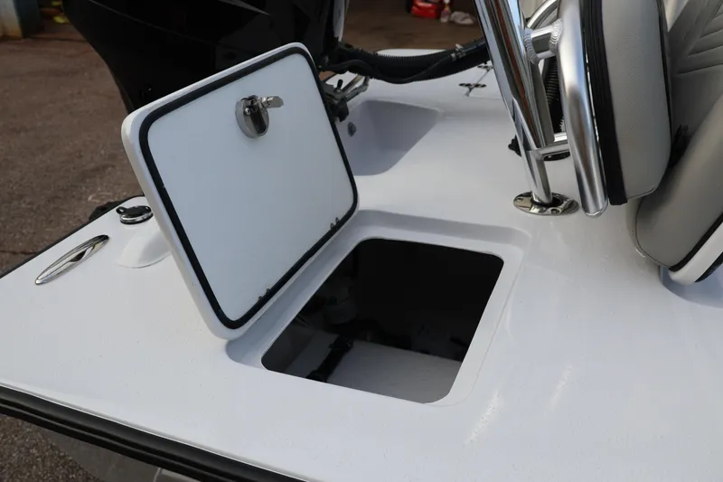 Slide: The Image of Open storage compartment on 2025 Custom Texar Flats Hybrid 16 boat deck. - 8