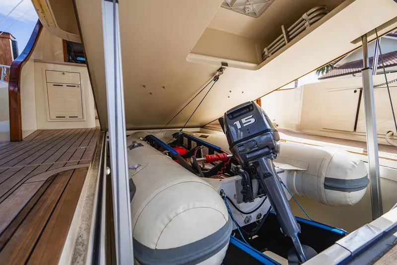 Slide: The Image of 2015 Palm Beach Motor Yachts PB52 with inflatable boat and outboard motor in storage compartment. - 11