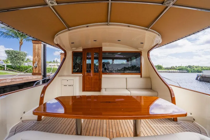 Slide: The Image of 2015 Palm Beach Motor Yachts PB52 interior with wooden table and seating area. - 14