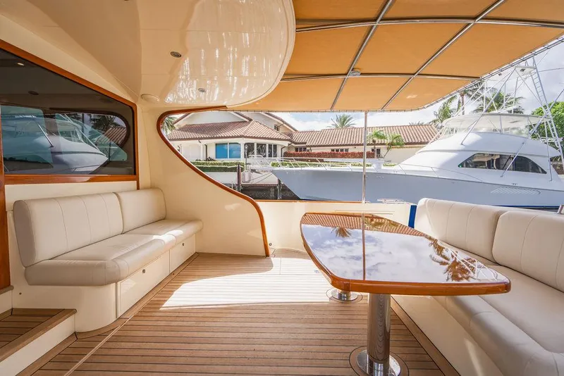Slide: The Image of 2015 Palm Beach Motor Yachts PB52 interior with elegant seating and polished wood table. - 15