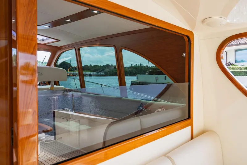 Slide: The Image of 2015 Palm Beach Motor Yachts PB52 interior with elegant wood finish and waterfront view. - 19