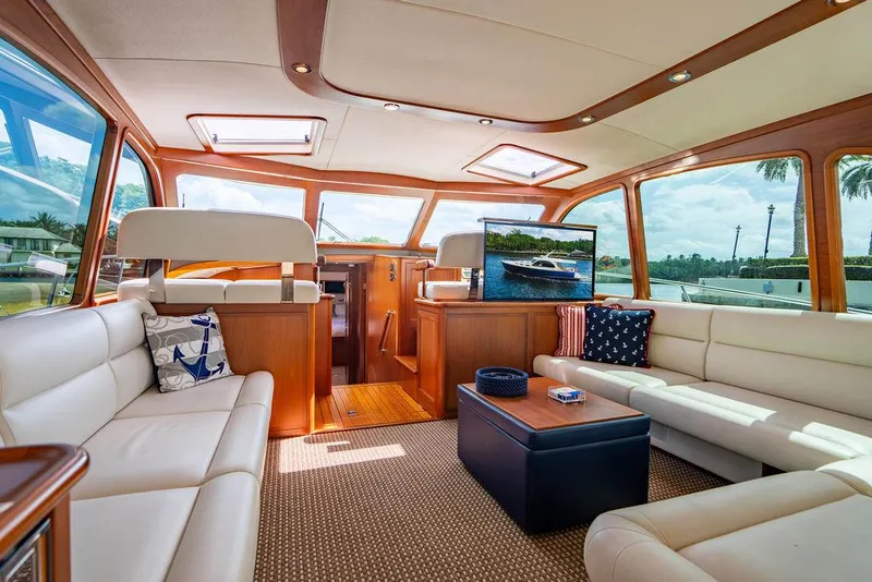 Slide: The Image of Luxurious interior of 2015 Palm Beach Motor Yachts PB52 with elegant seating and large windows. - 2