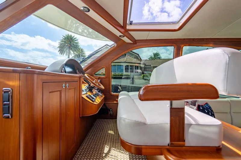 Slide: The Image of Interior of 2015 Palm Beach Motor Yachts PB52, featuring luxurious wood and leather seating. - 40