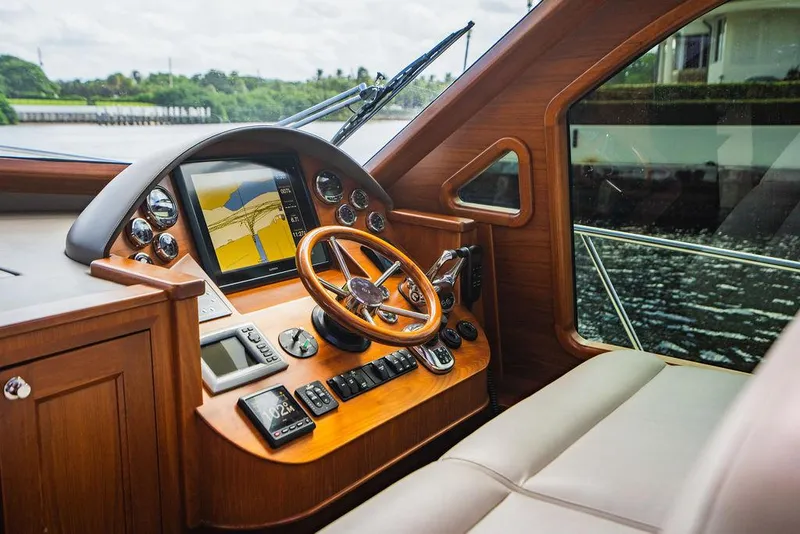 Slide: The Image of 2015 Palm Beach Motor Yachts PB52 helm with wooden steering wheel and navigation instruments. - 42