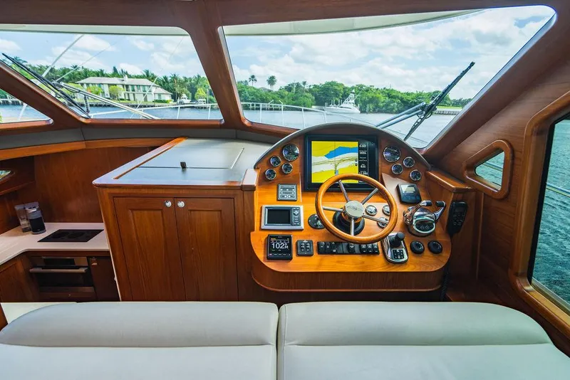 Slide: The Image of Helm of 2015 Palm Beach Motor Yachts PB52 with navigation instruments and wooden finish. - 43
