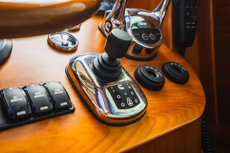 Slide: The Image of Control panel of a 2015 Palm Beach Motor Yachts PB52, featuring joystick and switches. - 47