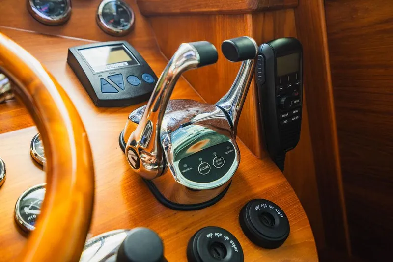 Slide: The Image of Control panel of 2015 Palm Beach Motor Yachts PB52 with throttle and navigation instruments. - 48