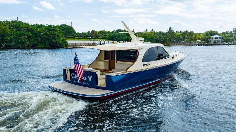 Slide: The Image of 2015 Palm Beach Motor Yachts PB52 cruising on a scenic waterway. - 5
