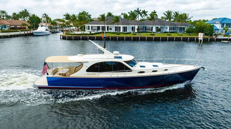 Slide: The Image of 2015 Palm Beach Motor Yachts PB52 cruising on a scenic waterway. - 6