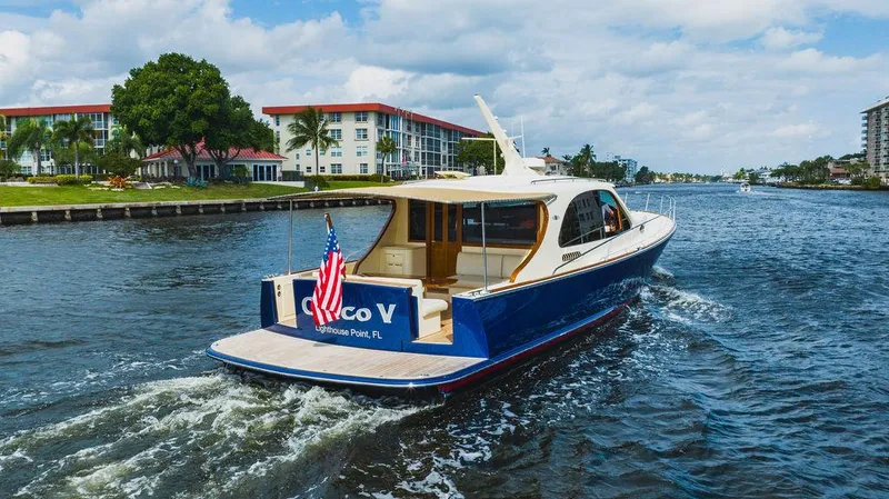 Slide: The Image of 2015 Palm Beach Motor Yachts PB52 cruising on a scenic waterway. - 8