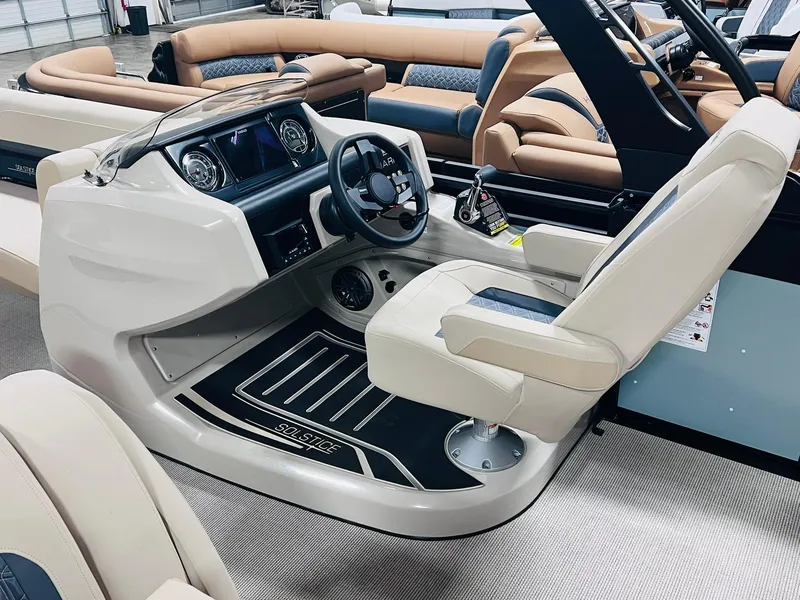 Slide: The Image of 2025 Harris Solstice 250 boat interior with modern helm and beige seating. - 16