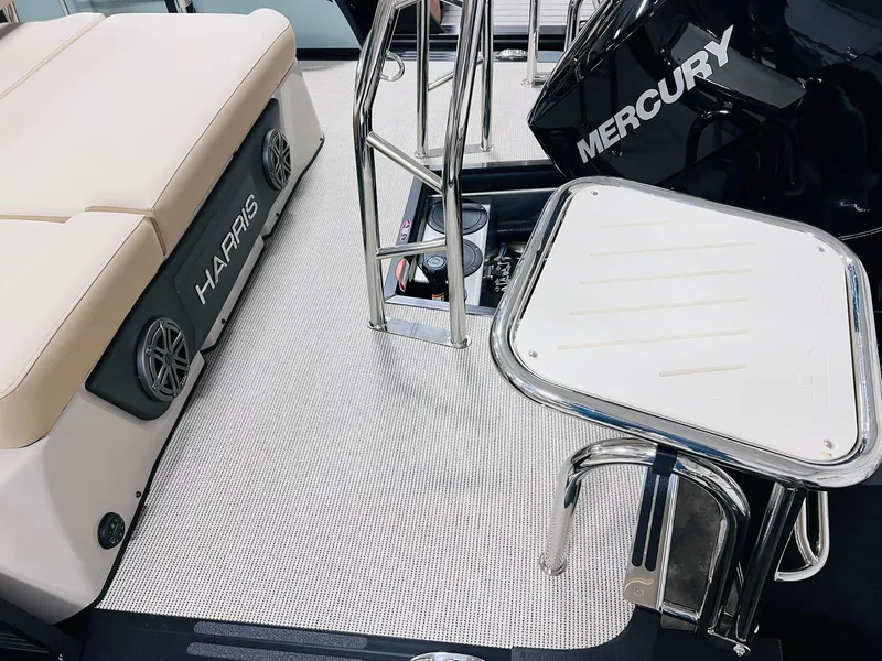 Slide: The Image of 2025 Harris Solstice 250 boat deck with Mercury engine and seating area. - 19