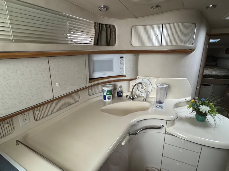 Slide: The Image of Interior of 1995 Sea Ray 450 Sundancer yacht kitchen with sink, microwave, and cabinets. - 10