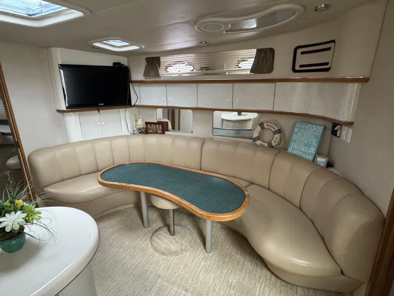 Slide: The Image of Luxurious interior of 1995 Sea Ray 450 Sundancer yacht with curved seating and TV. - 11