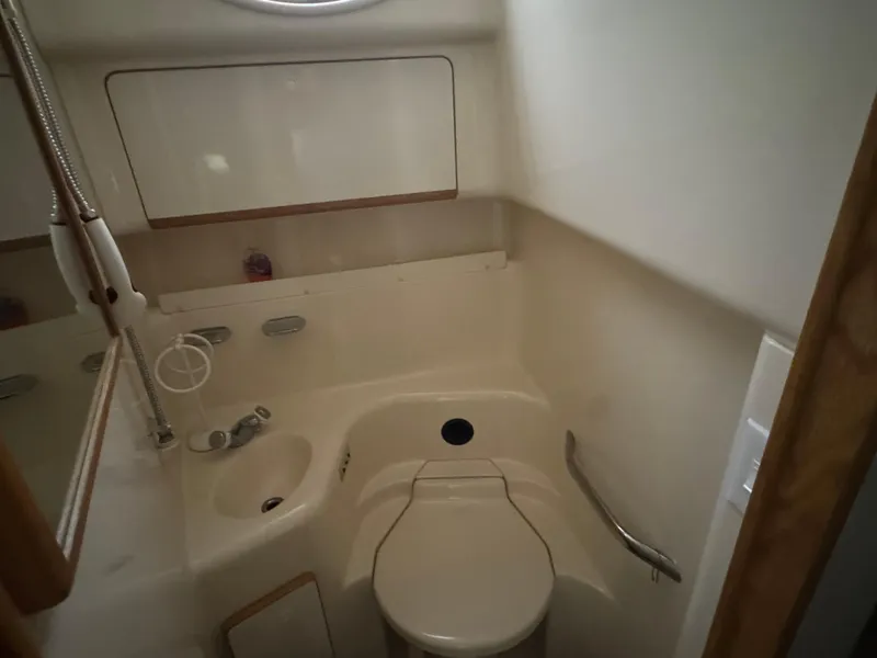 Slide: The Image of Bathroom interior of 1995 Sea Ray 450 Sundancer yacht, featuring compact design and fixtures. - 12