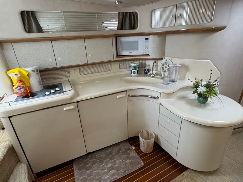 Slide: The Image of 1995 Sea Ray 450 Sundancer yacht kitchen with modern appliances and elegant cabinetry. - 14