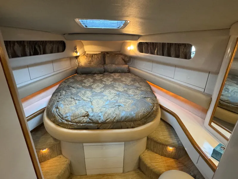 Slide: The Image of Luxurious cabin interior of 1995 Sea Ray 450 Sundancer yacht with cozy bed and ambient lighting. - 17