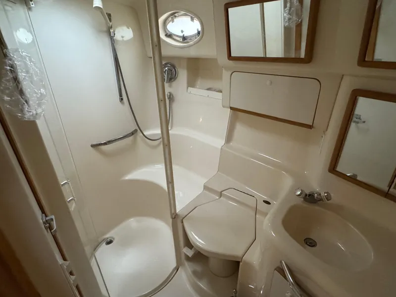 Slide: The Image of Bathroom interior of 1995 Sea Ray 450 Sundancer yacht, featuring shower and sink. - 19