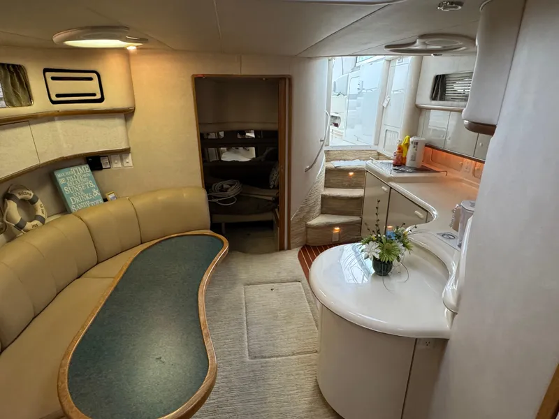 Slide: The Image of Interior of a 1995 Sea Ray 450 Sundancer yacht with cozy seating and kitchenette. - 20
