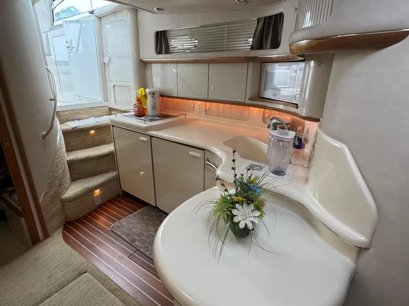 Slide: The Image of Luxurious 1995 Sea Ray 450 Sundancer yacht interior with modern kitchen and elegant decor. - 21