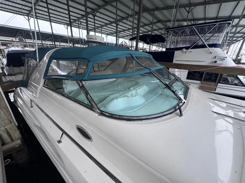Slide: The Image of 1995 Sea Ray 450 Sundancer docked under a marina roof. - 4