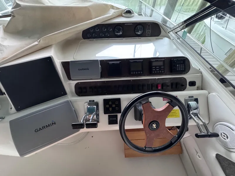 Slide: The Image of 1995 Sea Ray 450 Sundancer helm with Garmin navigation and classic steering wheel. - 8