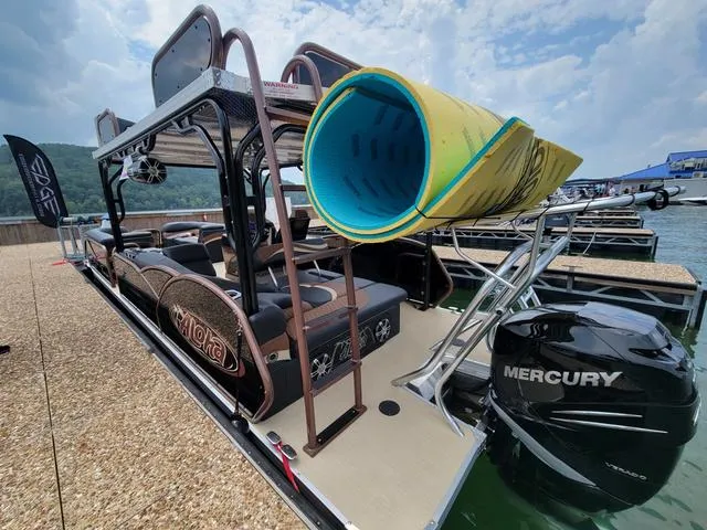 Slide: The Image of 2025 Aloha 30' Paradise Sundeck boat with Mercury engine docked by the lake. - 13
