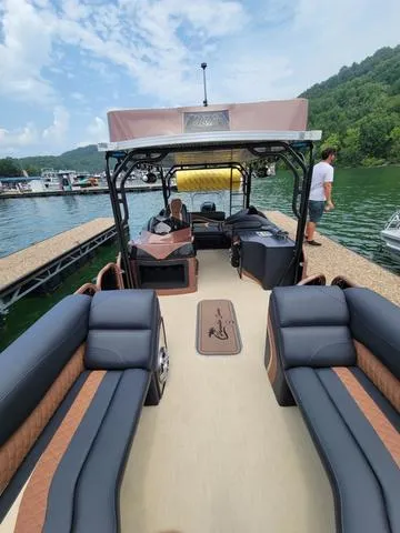 Slide: The Image of 2025 Aloha 30' Paradise Sundeck boat docked on a scenic lake. - 17