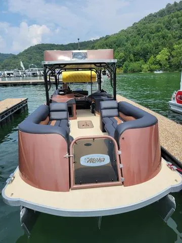 Slide: The Image of 2025 Aloha 30' Paradise Sundeck boat docked on a serene lake with lush green hills. - 20