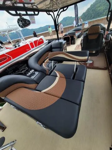 Slide: The Image of 2025 Aloha 30' Paradise Sundeck with luxurious seating and scenic backdrop. - 28