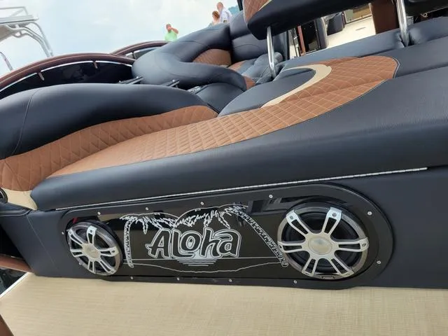 Slide: The Image of 2025 Aloha 30' Paradise Sundeck with stylish seating and integrated speakers. - 29