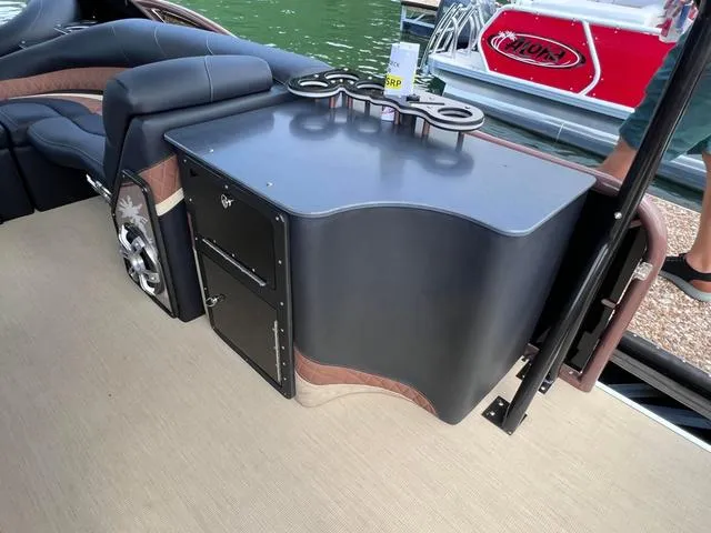 Slide: The Image of Aloha 30' Paradise Sundeck 2025 interior with sleek seating and storage. - 35