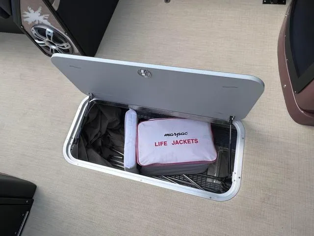 Slide: The Image of Storage compartment on 2025 Aloha 30' Paradise Sundeck with life jackets. - 36