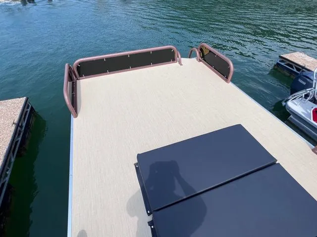 Slide: The Image of Aloha 30' Paradise Sundeck 2025 on water, featuring spacious deck area. - 46