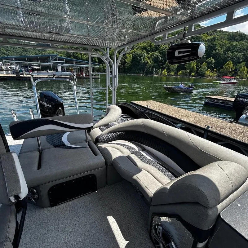 Slide: The Image of Luxurious seating on 2025 Aloha 30' Paradise Sundeck boat, docked by a scenic lake. - 7