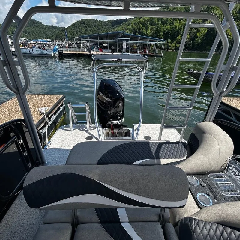 Slide: The Image of 2025 Aloha 30' Paradise Sundeck boat interior with lake view and dock in background. - 8