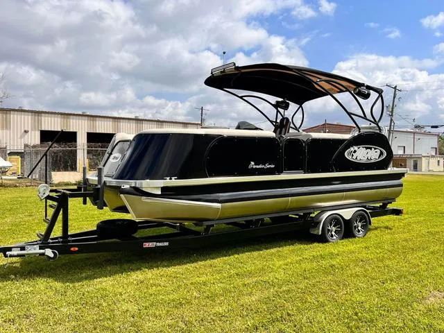 The Image of 2025 Aloha 23' Paradise Arch Sport Tower pontoon boat on trailer, parked on grass. - 1